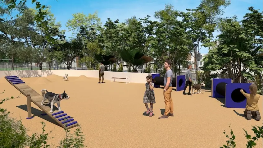 A man and a girl with a dog at a dog park in Samala Playa del Carmen