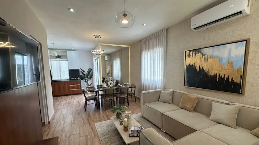 A living room with a sofa and a table in Samala Playa del Carmen