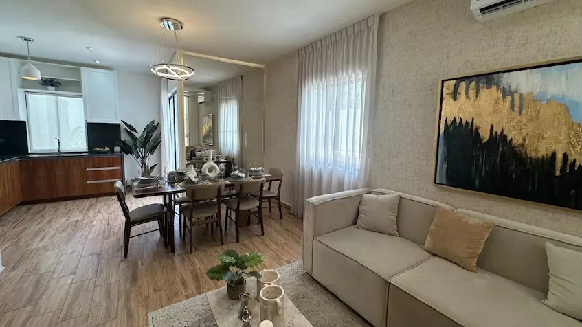 A living room with sofa and dining table at Samala Playa del Carmen