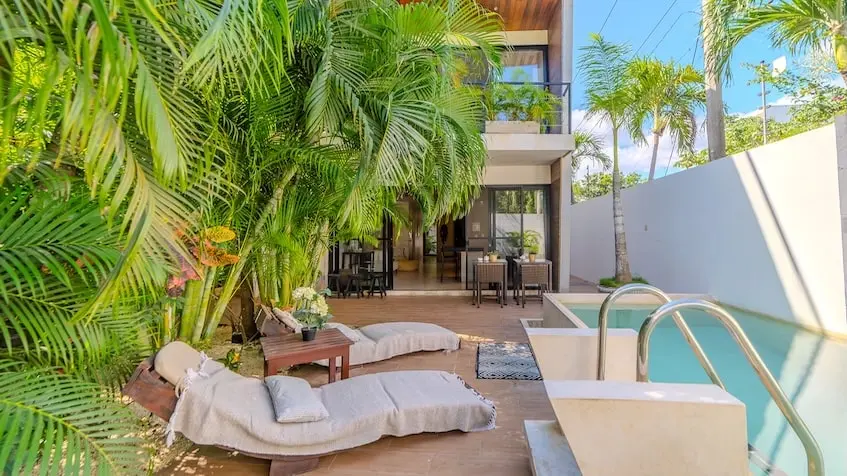Swimming pool with lounge chairs at Casa Caramelo Tulum