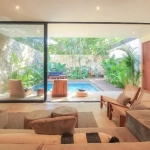 Living room with pool view at Villa Kaan Tulum