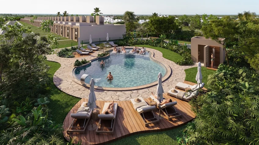 Vista aérea de una alberca familiar tipo oasis con camastros de madera y sombrillas, rodeada de áreas verdes y residencias de The Origin By Gran Selva Puerto Morelos
