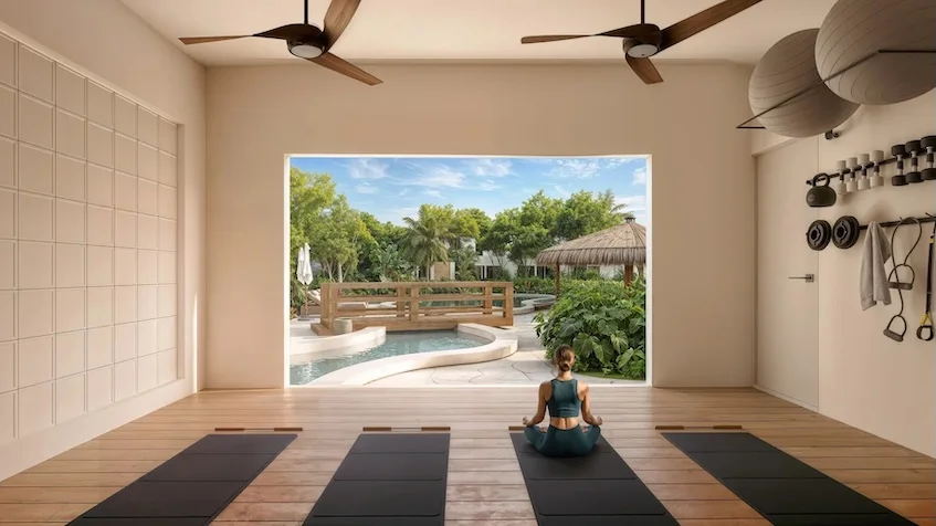 Área de yoga que incluye tapetes en el suelo, pesas y accesorios en la pared, ventiladores de techo y un gran ventanal con vista exterior de alberca y vegetación de The Origin By Gran Selva Puerto Morelos
