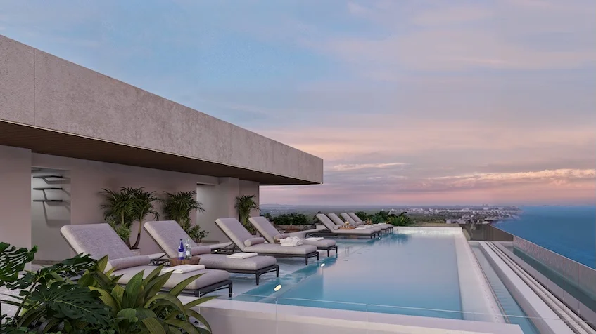 Zona de asoleadores y alberca infinity con vista al mar en Village Blu Puerto Morelos