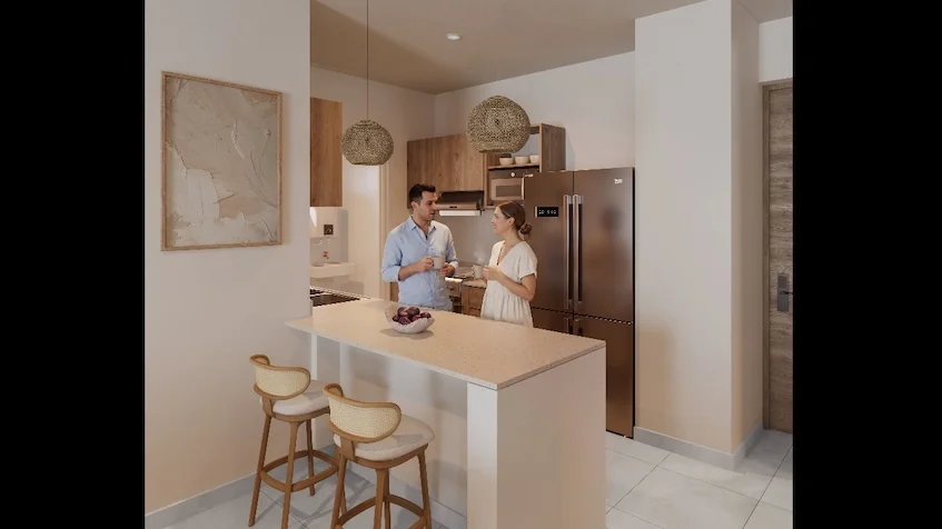 Vista interior que incluye una cocina abierta, un comedor con barra desayunadora, gabinetes de madera