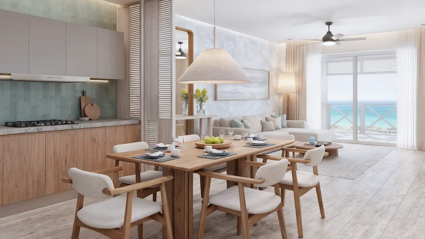 Sala, comedor y cocina que incluye una mesa con sillas, una lámpara colgante, gabinetes, un sofá, una mesa de centro y un ventilador de techo de Isola BLU Isla Mujeres.