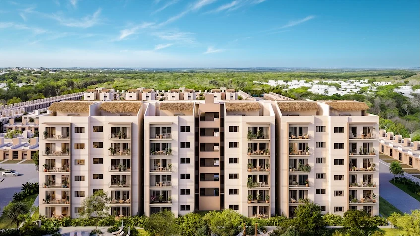 Vista aérea y fachada de un complejo residencial que incluye edificios con balcones, áreas verdes, vegetación