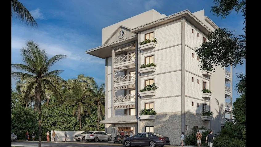 Fachada lateral de un edificio que incluye balcones, ventanas, un área de estacionamiento con automóviles, palmeras y personas de Isola BLU Isla Mujeres.