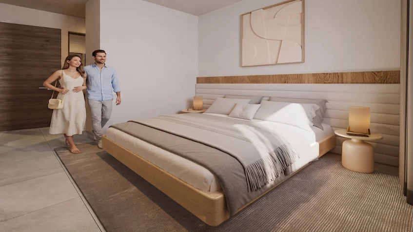 Vista de recámara principal que incluye una cama con cabecera de madera y decoración textil, un buró con lámpara, y una obra de arte en la pared de The Origin By Gran Selva Puerto Morelos.