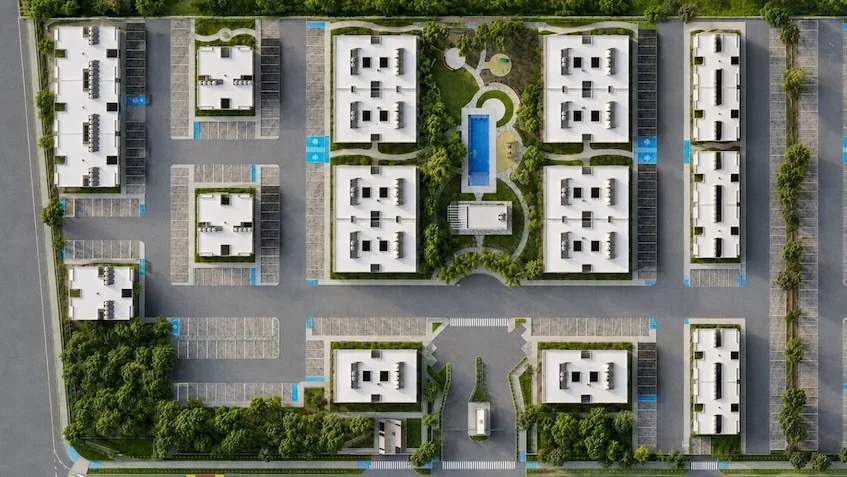 Vista aérea del plan maestro que incluye edificios residenciales, áreas verdes, estacionamientos, una alberca central y vialidades internas de Vía Verde Playa del Carmen.